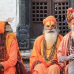 three men wearing orange tradition